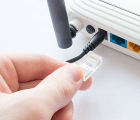 Mano conectando un cable del router